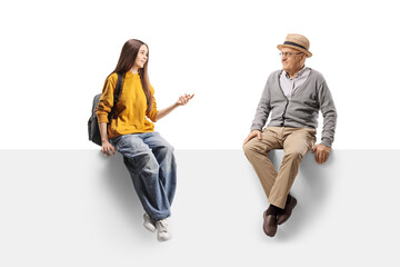 Female teenager sitting on a panel and talking to a senior man