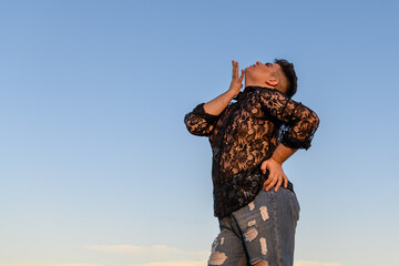 Non-binary person dancing on the roof