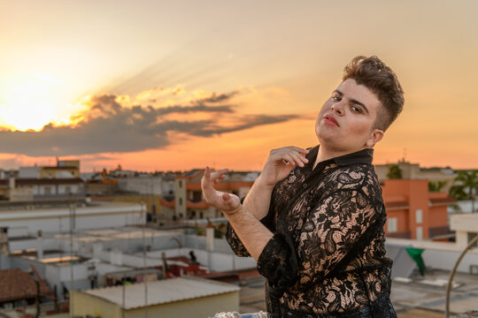 Non-binary person portrait on the roof at sunset