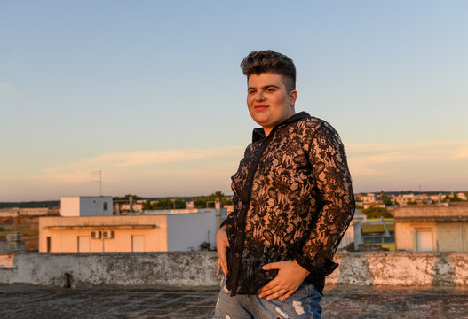 Smiling happy non-binary person dancing on the roof