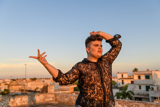 Portrait of non-binary person on the roof at sunset