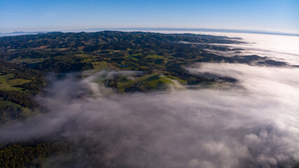 APRIL 4, 2024, PASO ROBLES, CA - drone view of fog, clouds over spring fields in Central CA