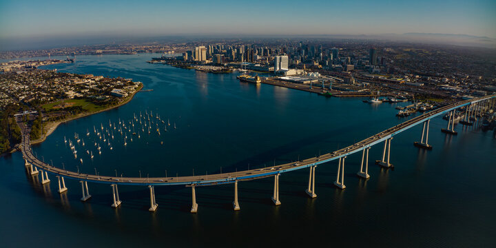 APRIL 2024, SAN DIEGO, CA. USA - sunrise view of Coronado Bridge with San Diego Skyline in view from Coronado