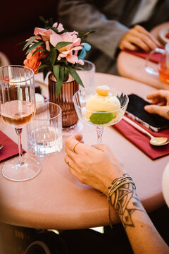 elegant dining with dessert and drinks at a stylish round table