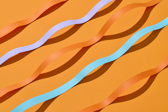 Colorful Ribbons on Orange Background Abstract Pattern