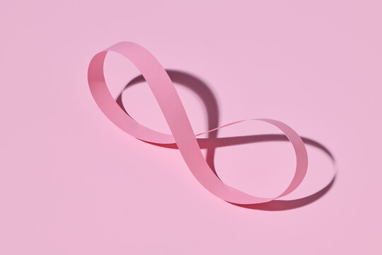 Pink Paper Infinity Loop on Pastel Background