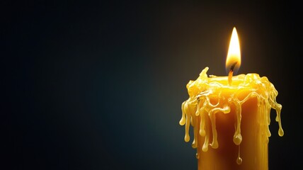 Close-up of burning candle with melted wax against dark background