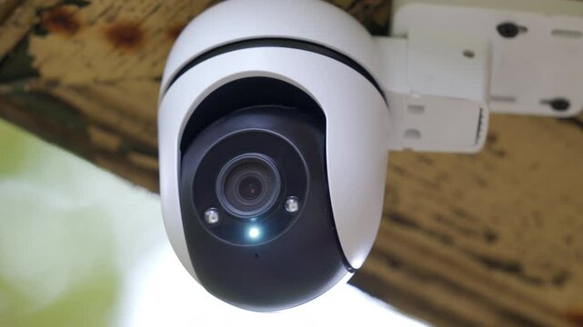 Security outdoor PTZ surveillance camera installed under the roof of the house. Pan tilt zoom camera provide HD view zoom and 360 rotation for full security coverage.