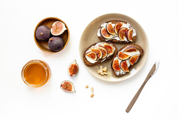 Top view of breakfast table with fig, cheese and honey sandwiches