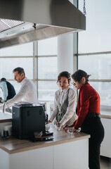 A group of multicultural business workers engage in conversation around a coffee machine in an office kitchen. The atmosphere is friendly and collaborative, highlighting workplace camaraderie and team