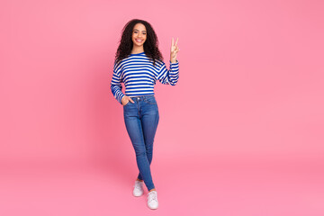 Full body portrait of nice young girl show v-sign empty space isolated on pink color background