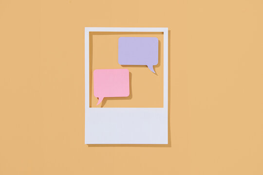 Colorful Speech Bubbles Inside a Polaroid Frame on Orange Backgr