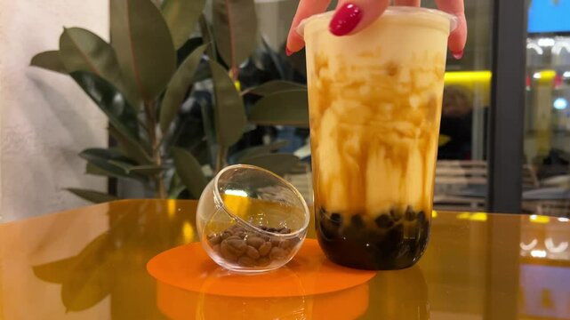 Bubble Tea drink Taiwan milk tea with bubble and cheese burned on wood table