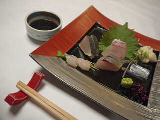 Shikoku local sashimi specialties from Setouchi sea, fresh sea-bream, mackerel and conger eel on ceramic plate