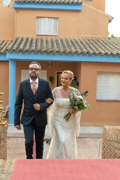Mother and son walking to altar to celebrate golden wedding day 