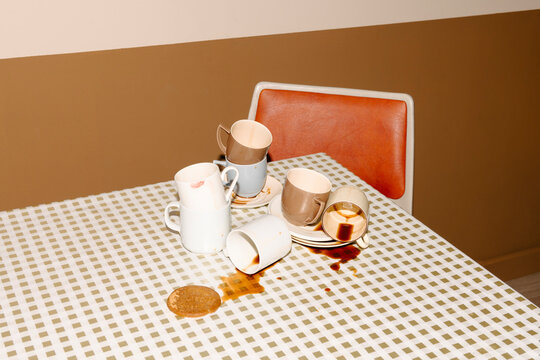 Messy Table with Coffee Spills and Empty Cups