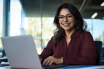 Fototapeta premium Young businesswoman working on laptop computer in company office, business, working, trends, Ai