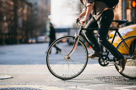 City Commuter Riding a Bicycle in Urban Traffic