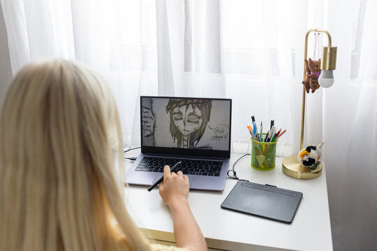 Teenage child working on digital illustration