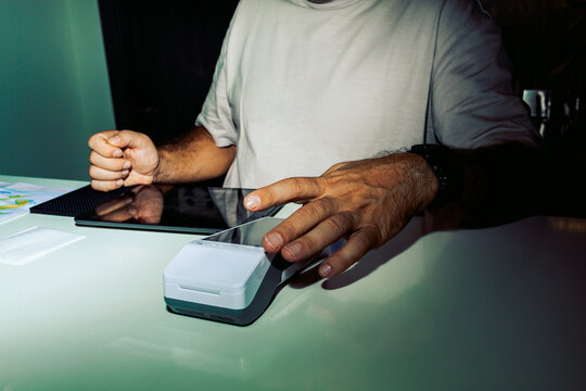Man operating point of sale machine