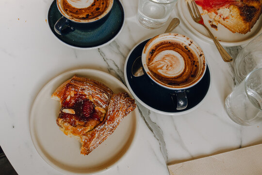 Having pastries and cup of coffees at a cafe 