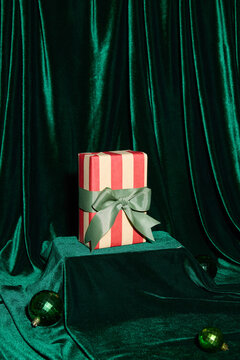 Festive Gift Box with Red and White Stripes on Velvet