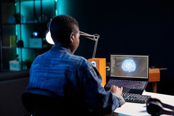 African American developer manages futuristic database with artificial intelligence. Black woman...