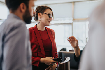 A group of multiracial business people having a vibrant conversation in a modern office setting....