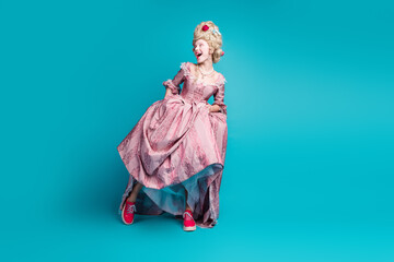 Full length photo of young woman look empty space wear renaissance queen costume isolated on teal color background