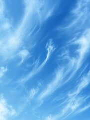 A serene blue sky with wispy clouds creating a peaceful atmosphere.