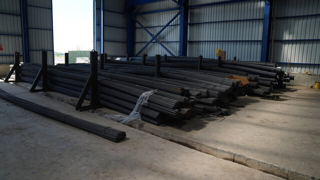 long reinforcing bars stacked in the warehouse