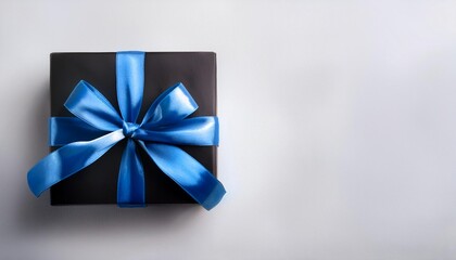 Black Gift Box with Blue Ribbon on White Background. Top View of Brotherhood Day Gifts with Copy Space