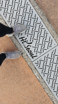 POV Feet next to Hi Seoul sign