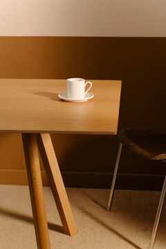 Minimalist Coffee Cup on Wooden Table in Sunlit Room