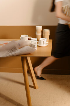 Busy Workplace Table with Coffee Cups and Papers
