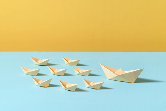 Transnational business concept origami light yellow paper boats