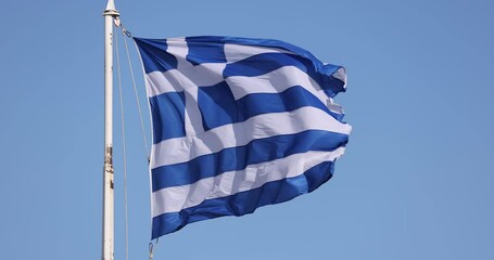 Slow motion video of the Greek flag waving in Athens over the Acropolis