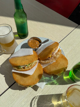Detail shot of arepas placed on a plate on a table ready to be eaten