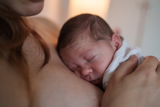 Baby sleeps peacefully in mother's arms