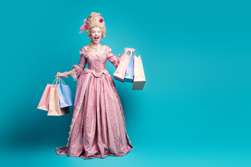 Full size portrait of young princess girl store bags empty space wear vintage dress isolated on...
