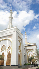 Beautiful Mosque Architecture Against a Vibrant Blue Sky with White Clouds