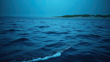 Dark blue ocean waves gently lapping against a sandy beach in the distance, marine landscape, coastal scenery, underwater scene