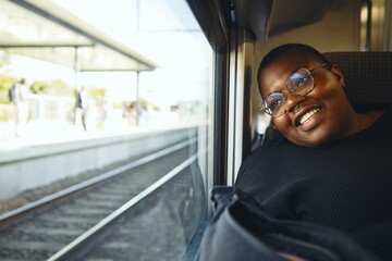 Happy traveler viewing from train window