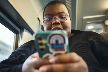 Captivated by a smartphone during a train journey