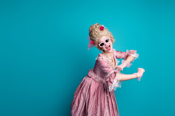 Portrait of young princess girl dance empty space wear vintage dress isolated on turquoise color...