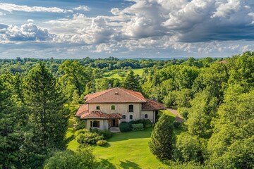 Aerial view of a luxury house nestled in a lush green landscape.