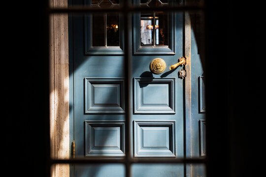 Vintage Blue Door with Decorative Handle and Shadows