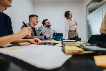 A diverse group of business people, including multicultural business workers, collaborate in a meeting room, brainstorming and analyzing a new project idea enthusiastically.