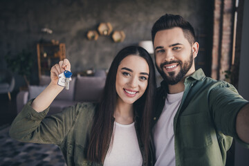 Photo of cute attractive woman man dressed casual shirts recording video vlog showing new home...