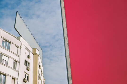 Empty old billboards on a building against a blue sky 